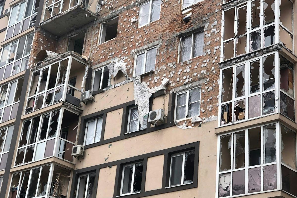 Apartment building facade damaged by shelling