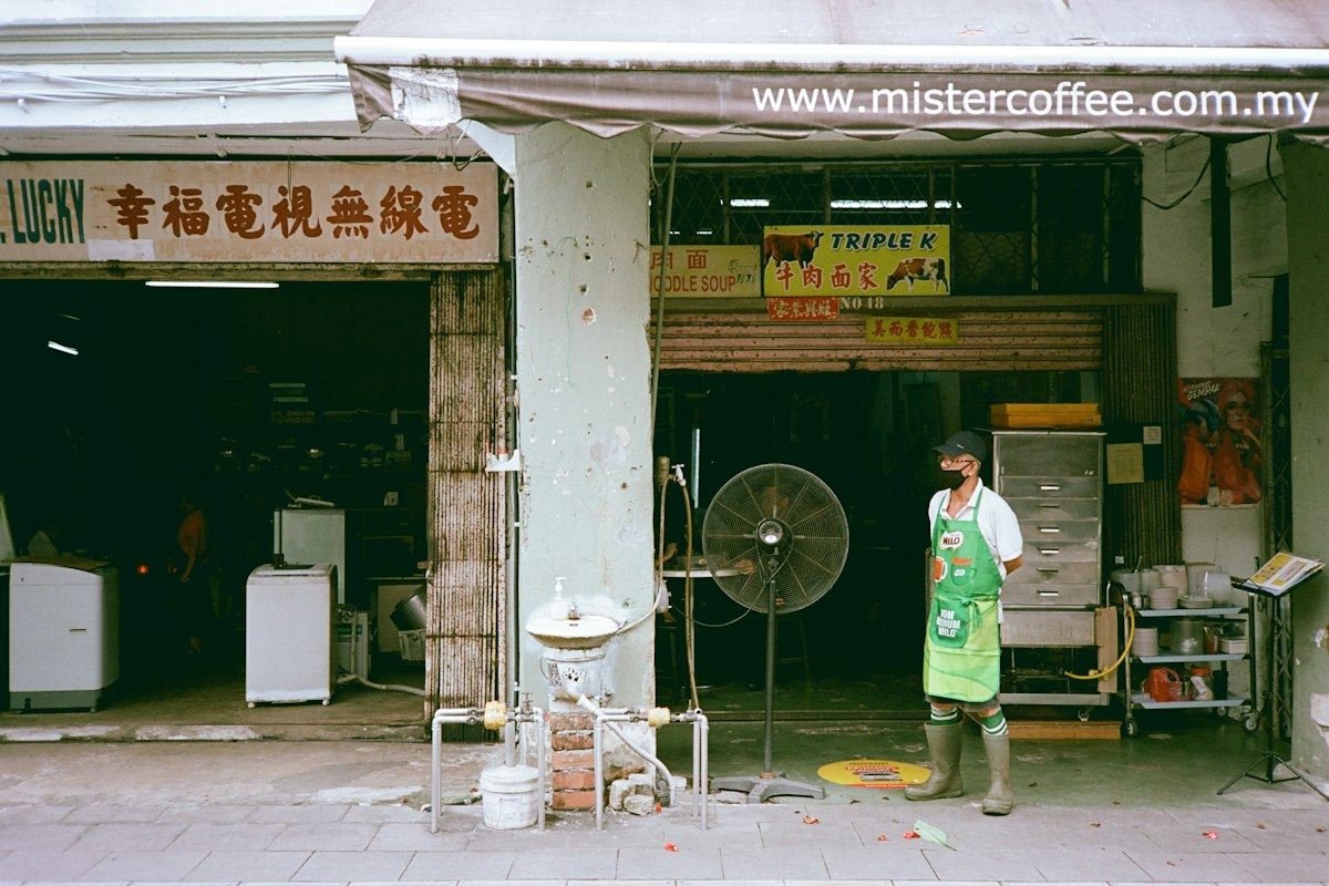 Man standing outside a shop with appliances