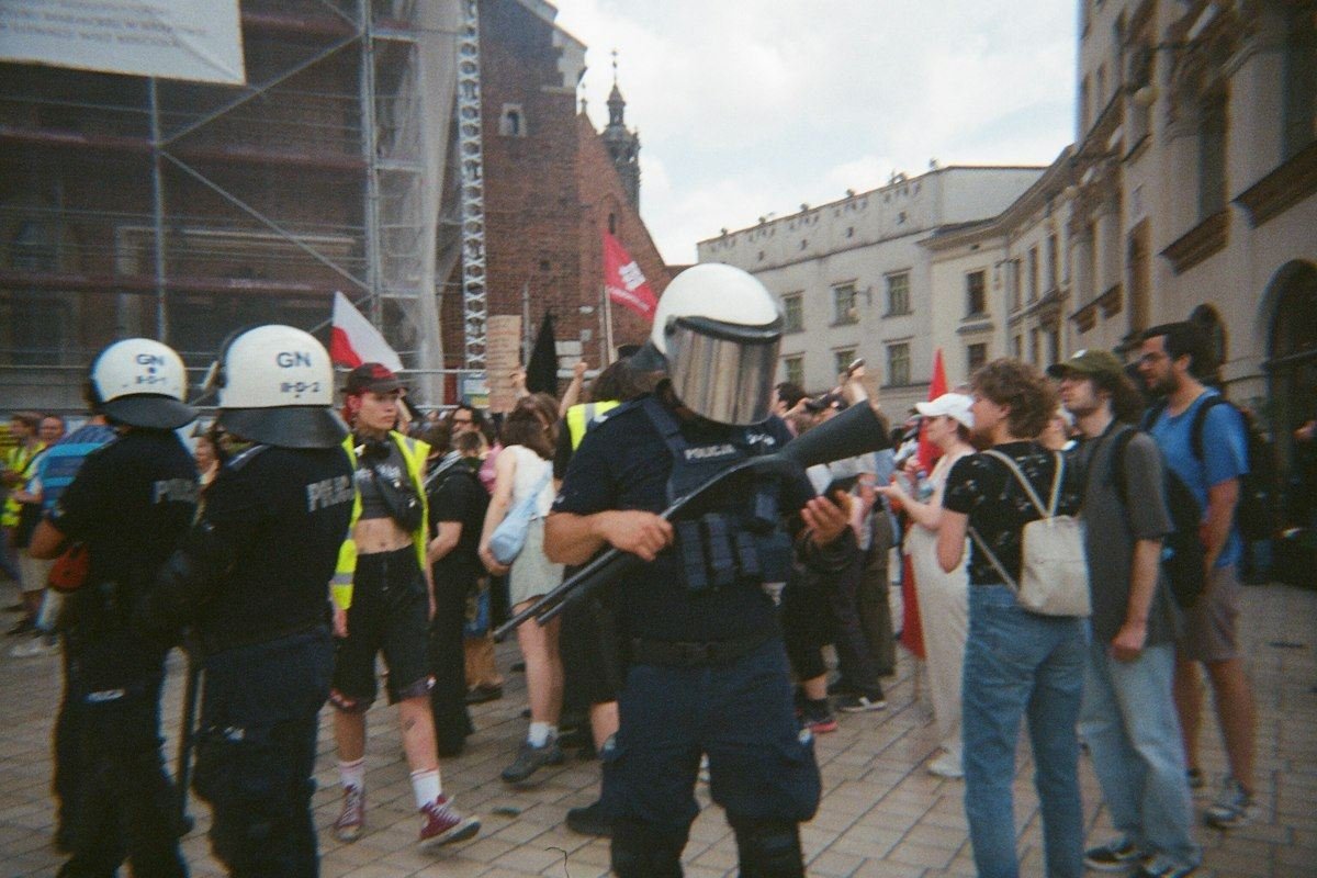 Police officers in riot gear with crowd in background