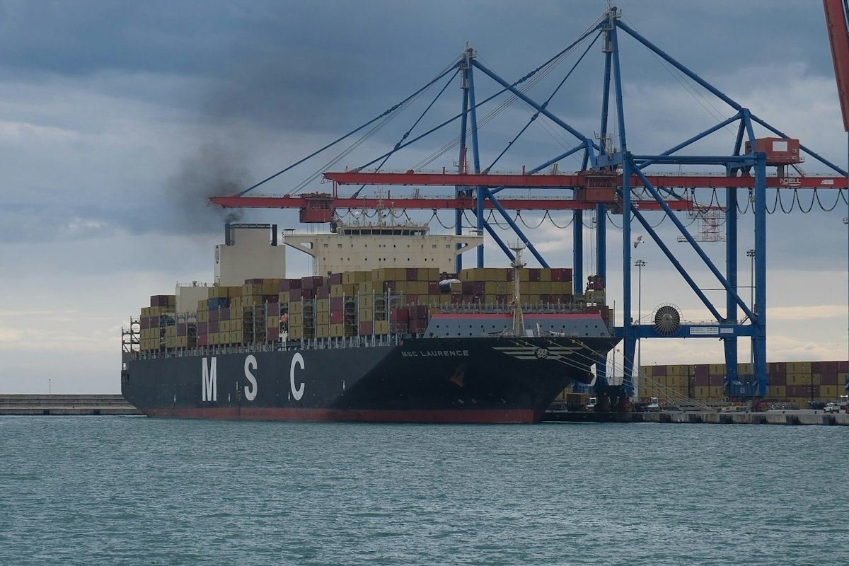 Container ship docked at a port with cranes