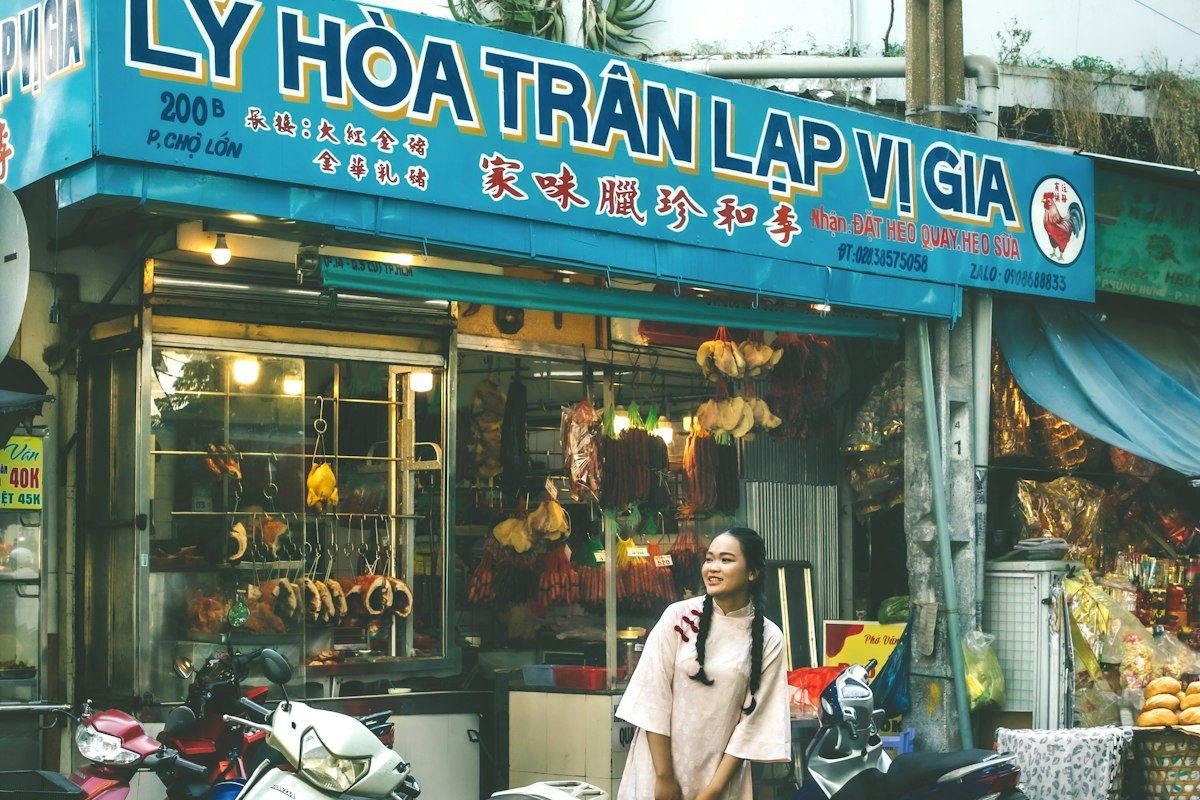 Woman standing outside a shop with motorbikes