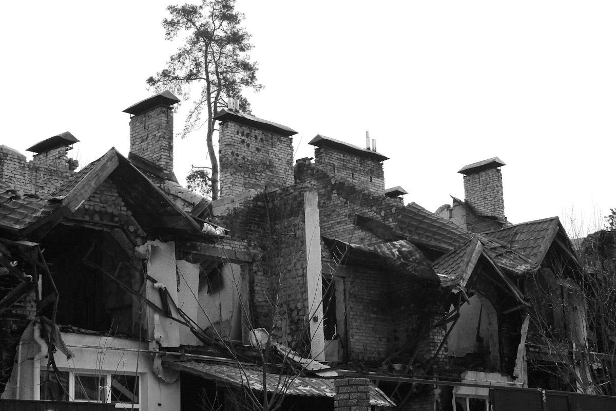 Damaged building with broken roof and chimneys