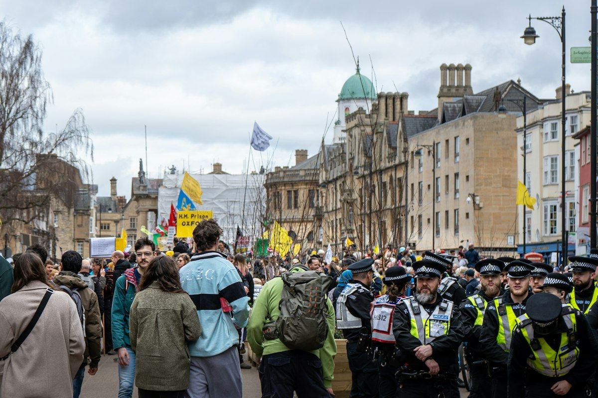 a group of police officers standing in front of a crowd of people