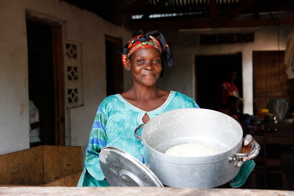 A woman prepares bread dough by hand at home