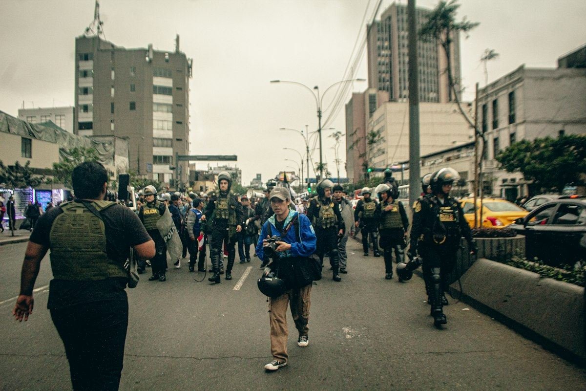 Protesters and police march down a city street
