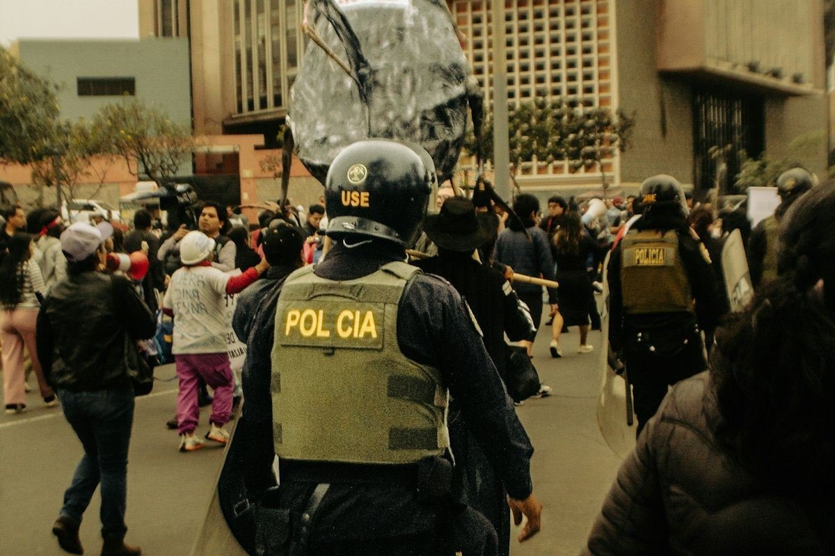 Police officers with riot gear in a street protest